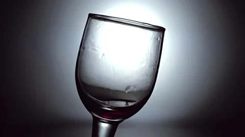 Slow motion of red wine being poured on crystal glass globlet Stock Footage 76816241