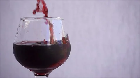 Slow motion red wine is poured into a glass. Stock Footage 119757643