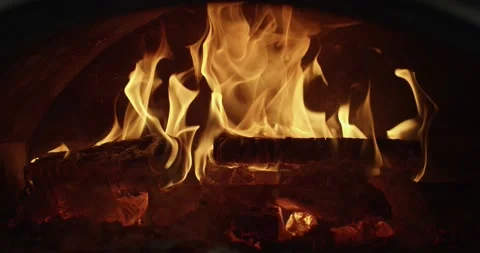 Slow motion as a red-yellow fire burns in a stove, fireplace, burning wood Stock Footage 130599583