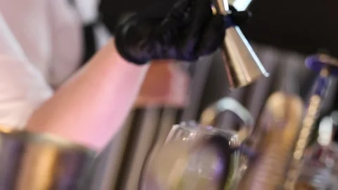 Slow Motion Refocus Shot of Bartender Pouring Fresh Drinks Behind Bar Counter Stock Footage 327482404