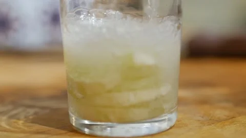 Slow motion of A refreshing soft drink. Mojito is poured into a glass close-up. Stock Footage 143780685