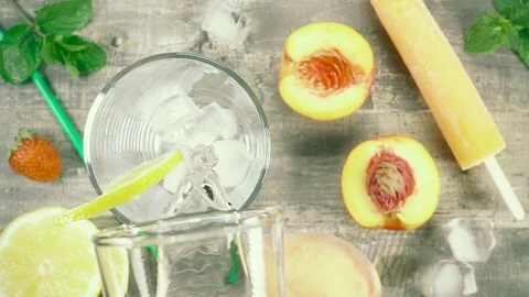Slow motion refreshment drink with ice in a glass top view Stock Footage 93240508