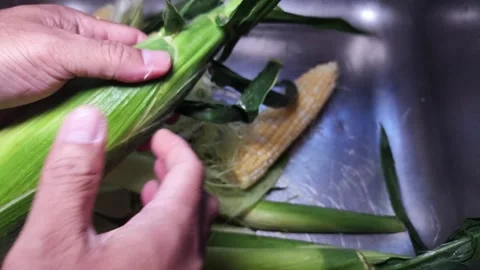 Slow motion Removing the corn husk Stock-Footage 338203197