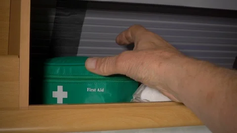 Slow motion - Removing a first aid kit from a cupboard in a caravan / motorhome. Stock-Footage 119581043