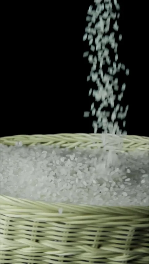 Slow Motion Rice Pouring into Basket Stock Footage 296123736
