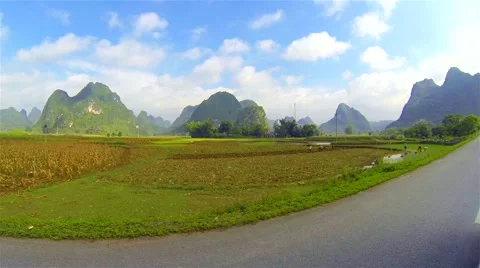 Slow motion ride through mountainous countryside with people planting rice. Stock Footage 54680505