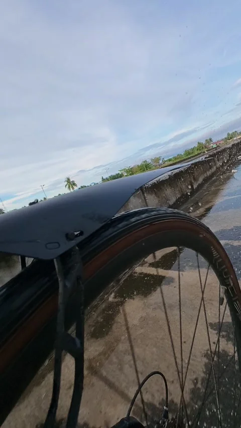 Slow Motion of Riding Bicycle Through Water Stock Footage 340269880