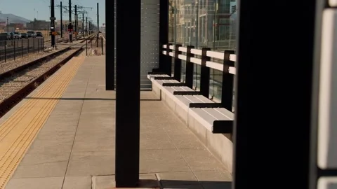 Slow motion right to left glide along empty transit platform and rail tracks Stock Footage 333149111