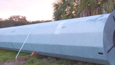 Slow motion right to left pan Horizontal View of Round Tapered Electrical Power Stock Footage 263904059