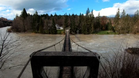 Slow motion right pan over rope suspension walking bridge Stock Footage 120457165