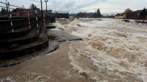 Slow motion right pan raging brown flooded water Stock Footage 121929445