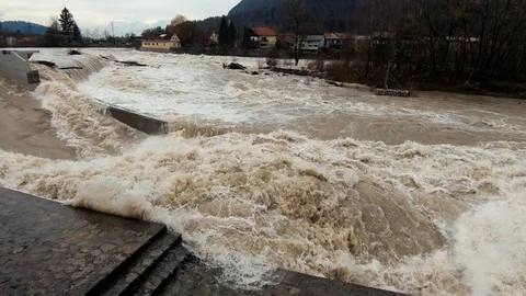 Slow motion right pan raging brown flooded water in Tacen whitewater Course Stock Footage 121929612