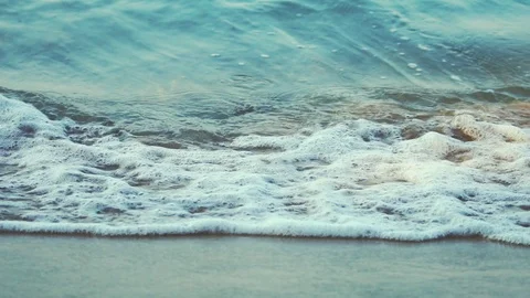 Slow motion of ripple wave at seashore. Clear water and Sand beach in the mornin Stock Footage 100804039