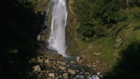 Slow motion rising above the waterfall in the green forest in georgia Stock Footage 100207152