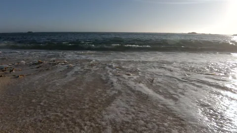 Slow motion rising shot from sand to air on beach in summer Stock Footage 133979720
