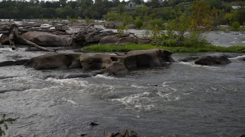 Slow Motion River Swelling Around Rocks in Richmond Virginia Stock Footage 252599137
