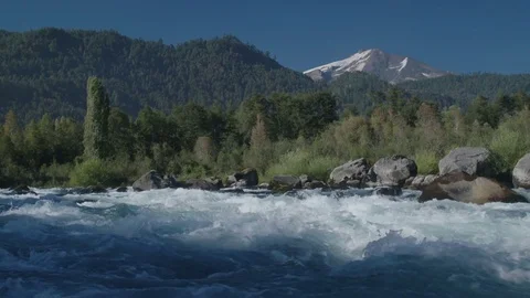 Slow Motion Of River Water Flowing Through Rapids In Front Of A Volcano In Chile Stock Footage 70377903