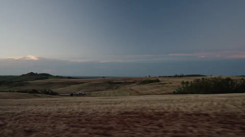 Slow-motion road trip through rolling farmland at dusk Stock-Footage 335689194