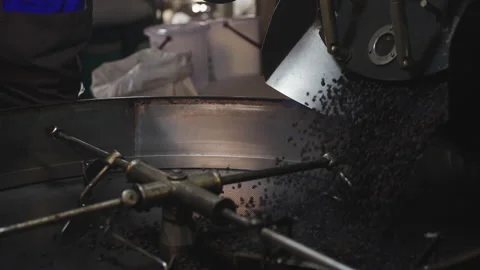 Slow motion, Roasted coffee beans are released from the roaster. Stock Footage 171806047