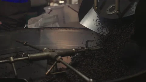 Slow motion, Roasted coffee beans are released from the roaster. Stock Footage 171806193