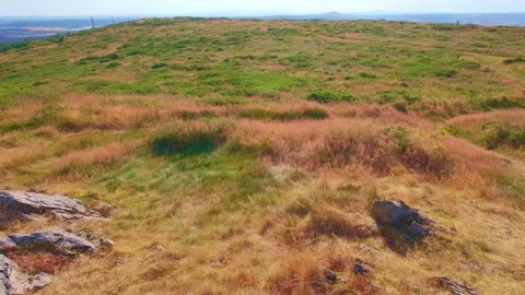 Slow motion rocky terrain on dry grassy hill slope Stock Footage 340441344