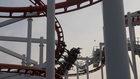 Slow motion: Roller coaster train slowly passing over the circuit in Dream Video stock 101326403