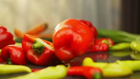 Slow motion rolling the pepper into the frame and hitting the half lying Stock Footage 296361952