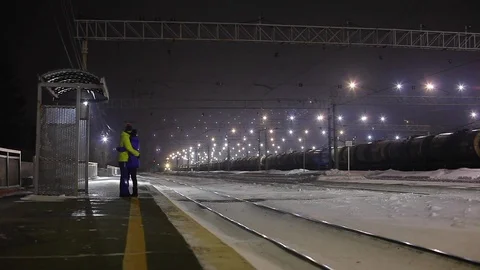 Slow Motion. Romantic couple talking at a train station. Stock Footage