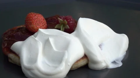 Slow motion of rotating batter cake with preserve, yoghurt and berries. Stock Footage 100236133