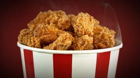 Slow Motion of Rotating Fried Chicken Pieces in Bucket on Colored Background. Stock Footage 281021746