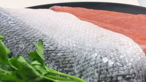 Slow motion of rotating raw salmon fillet and some green parsley Stock-Footage 79854449