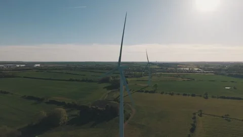 Slow motion rotating wind turbines over countryside landscape Stock-Footage 333934891
