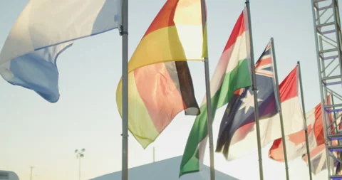 Slow motion row of international flags flapping in breeze Stock Footage 227598445