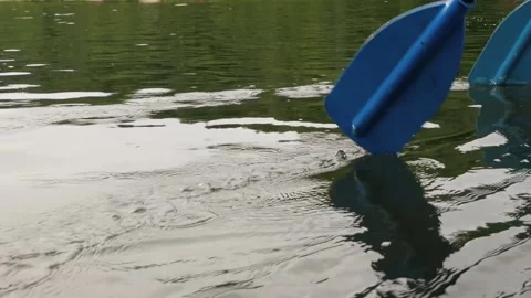 Slow motion rowing with two blue oars on the river Video stock 139798823