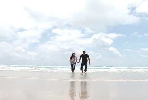 Slow motion running couple on the beach Stock Footage 1065630