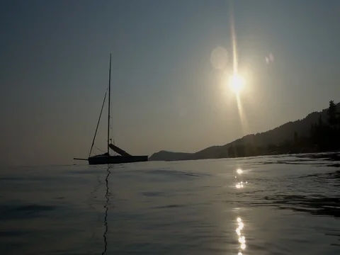 Slow motion of a sailboat at sunset on the beach Stock Footage 80593355