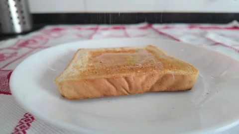 Slow Motion Salt Falling on Toasted Bread in 4K Stock Footage 341396507