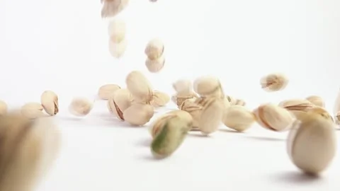 Slow Motion Salted Pistachios Falling on White Background 스톡 동영상 145992256