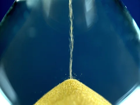 Slow motion sand timer flowing from through hour glass Stock Footage 84000139