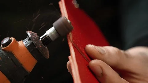 Slow motion sanding leather wallet edge with rotary tool Stock Footage 314962161