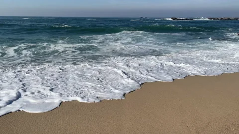 Slow motion sandy beach on bright sunny day. Pan up Stock Footage 146674620