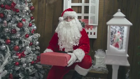 Slow motion of Santa Claus posing with wrapped Christmas gift boxes at festiv Stock-Footage 252383073