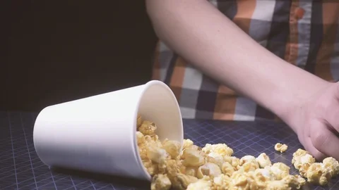 Slow motion scattered popcorn on the table and the boy pours a cola Stock Footage 87913411