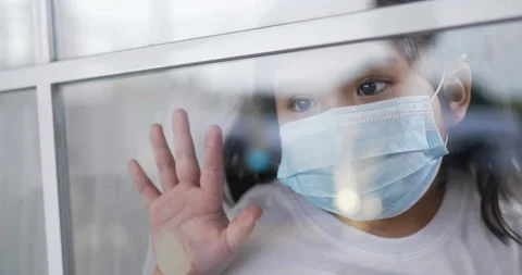 Slow motion scene, Through glass to little Asian girl in face mask looking  Stock Footage 200803433