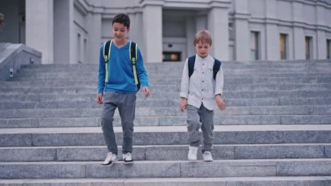 Slow motion of school kids getting down from staircase at school 4k. Video stock 161390530