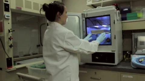 Slow Motion Scientist Puts Tray Of Samples In Incubating Machine Stock Footage 58226301
