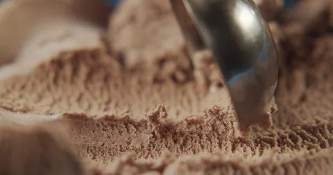 Slow motion of scooping chocolate ice cream with spoon. 4K video Stock Footage 120017226