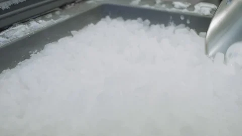SLOW MOTION Scooping dry ice out of a medical bucket. Stock Footage 127532533
