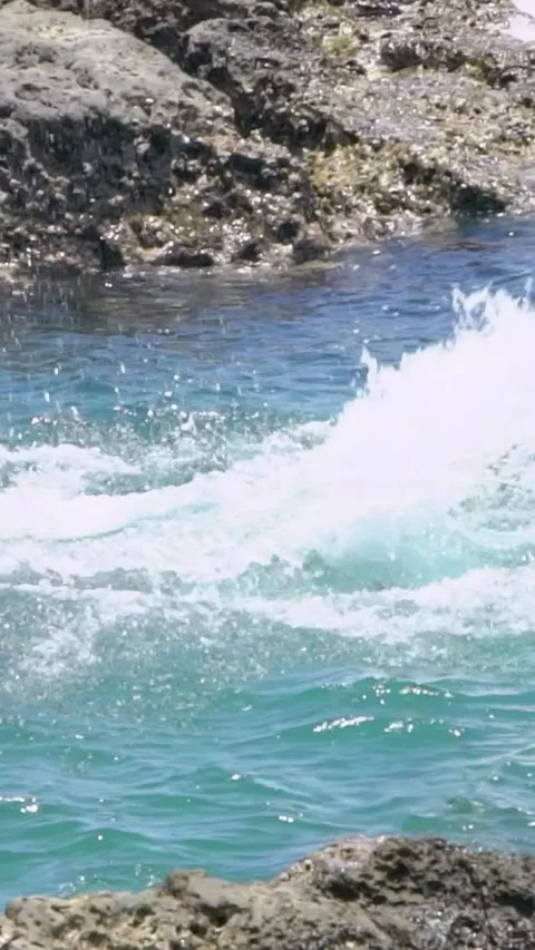 Slow Motion of scuba diver jumping in the water from rock of tropical coast. Stock Footage 312114375