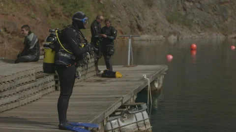 Slow Motion - Scuba Diver jumps off jetty into water Stock Footage 48587404